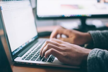 open laptop with hands typing