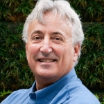 Grey haired man in a blue shirt