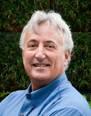 Grey haired man in a blue shirt