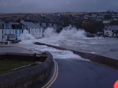 Coastal town with waves flooding over seafront roads